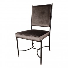 Upholstered chair with stylized blackened frame